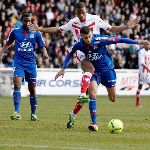 Lyon's Rachid Ghezzal keeps the ball away from Ajaccio's Ricardo Faty during the match in Ajaccio, on February 3, 2013
